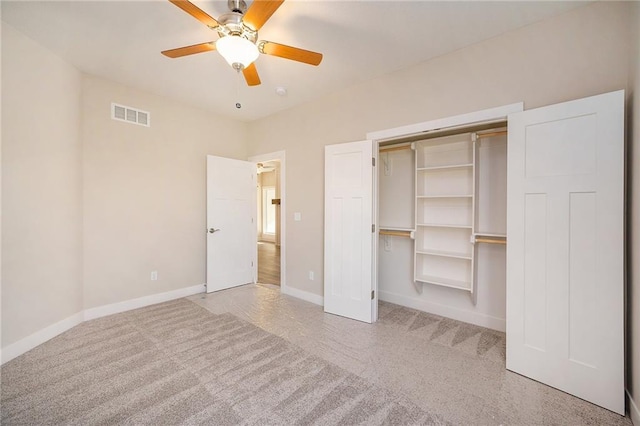 unfurnished bedroom with ceiling fan, a closet, and light carpet