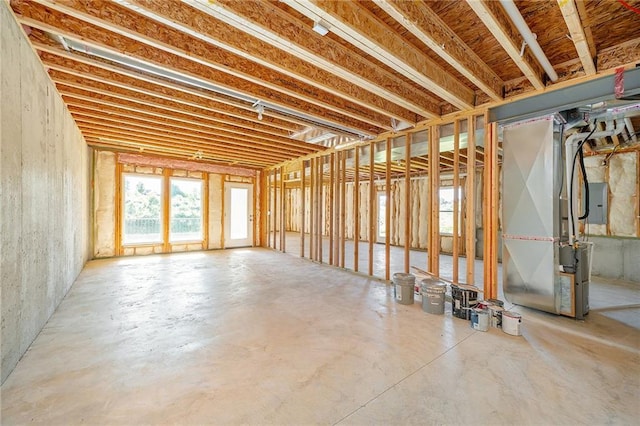 basement with heating unit and electric panel