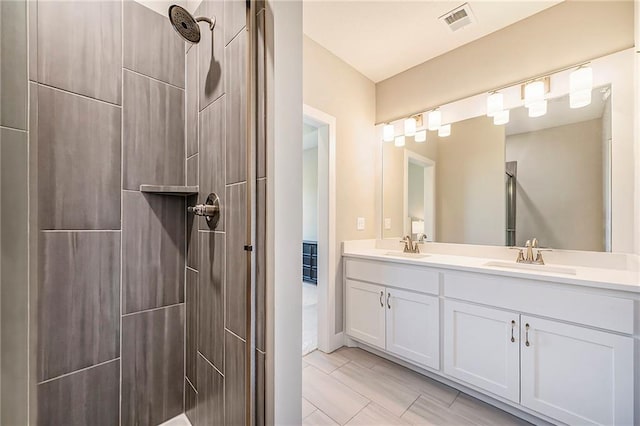 bathroom featuring vanity and a tile shower