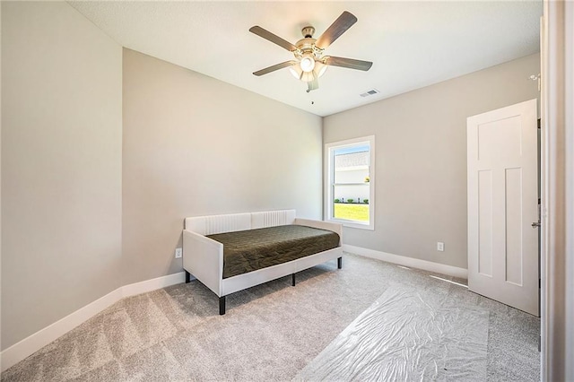 bedroom featuring light colored carpet and ceiling fan