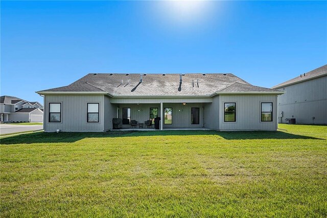 back of house with a yard and a patio area