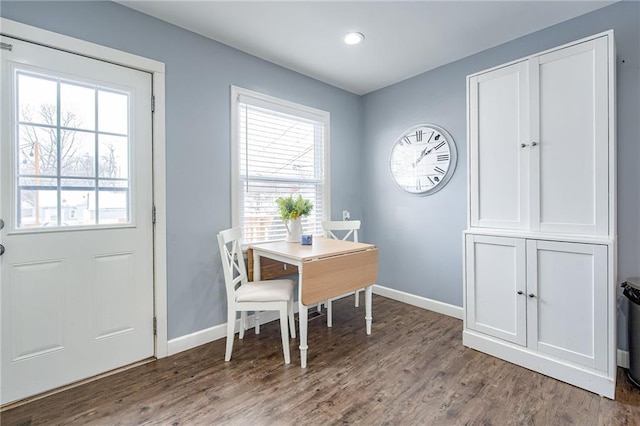 dining area with wood finished floors and baseboards