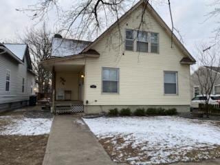 view of snow covered rear of property