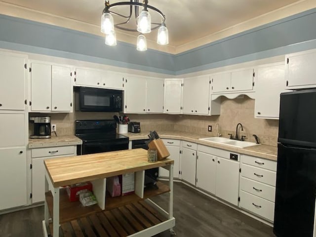 kitchen with sink, white cabinetry, hanging light fixtures, dark hardwood / wood-style floors, and black appliances