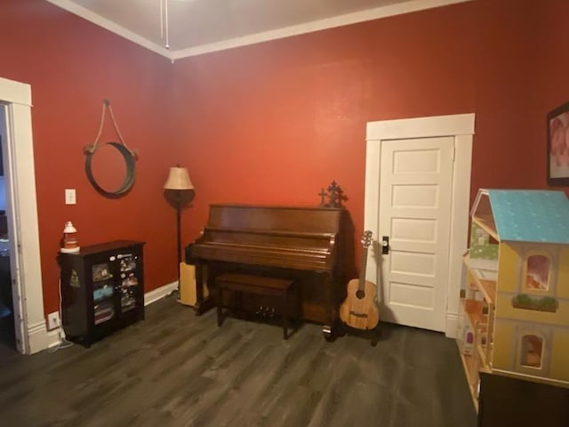 sitting room featuring crown molding and dark wood-type flooring