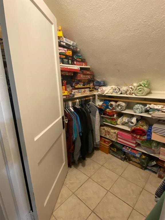 spacious closet featuring light tile patterned floors