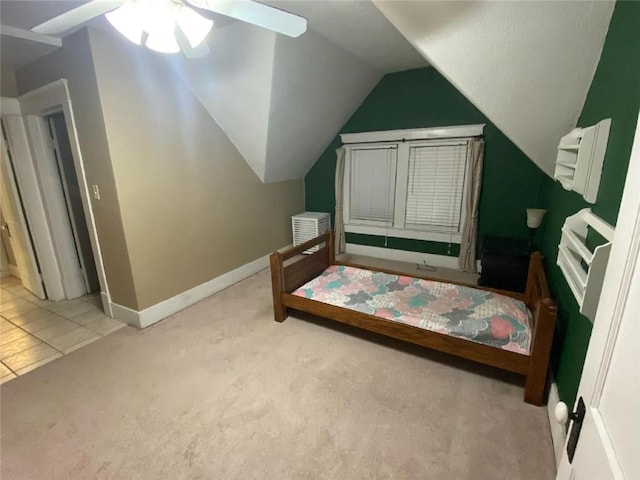 carpeted bedroom featuring ceiling fan and vaulted ceiling