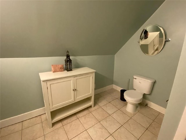 bathroom featuring tile patterned floors, toilet, and vaulted ceiling