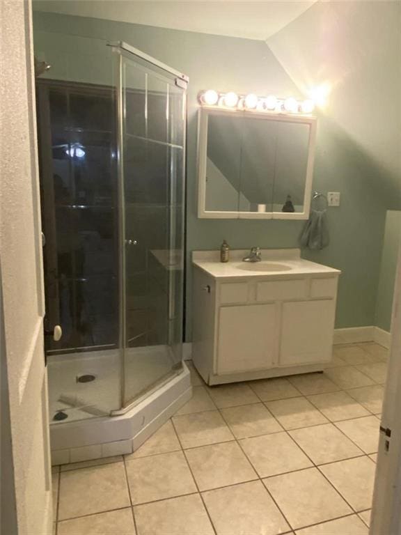 bathroom with vanity, tile patterned floors, and a shower with door