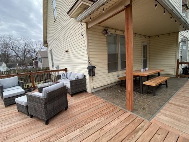 wooden terrace featuring an outdoor living space