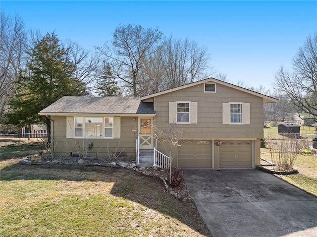 split level home featuring driveway, an attached garage, a front lawn, and a shingled roof