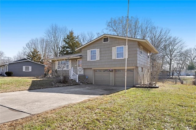 split level home featuring an attached garage, driveway, a front yard, and fence