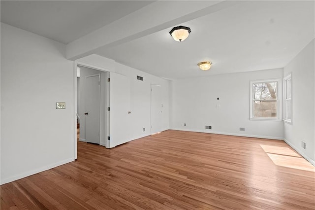 bonus room featuring light wood-style floors, visible vents, and baseboards