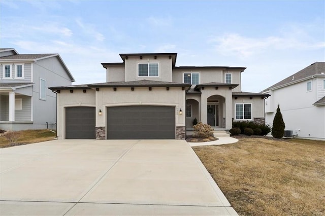 view of front of home with concrete driveway, stucco siding, stone siding, a front yard, and a garage
