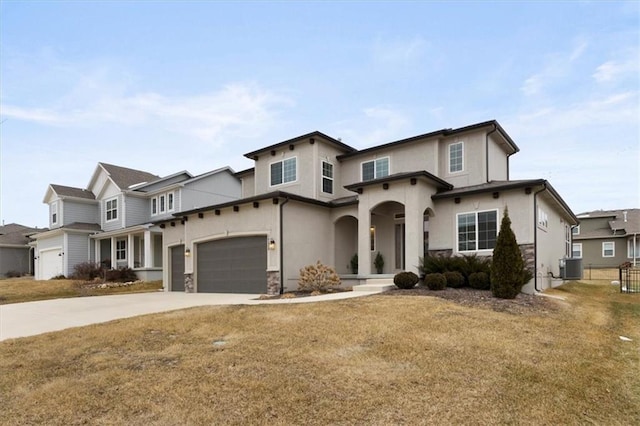 view of front of house featuring stucco siding, a front yard, central AC, a garage, and driveway