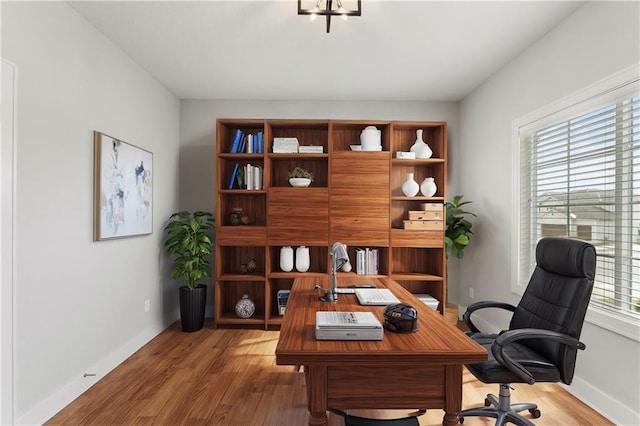 home office featuring wood finished floors and baseboards