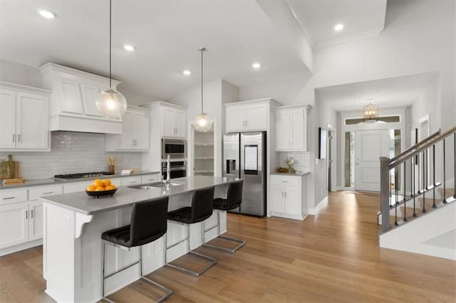 kitchen featuring appliances with stainless steel finishes, white cabinets, decorative backsplash, and recessed lighting