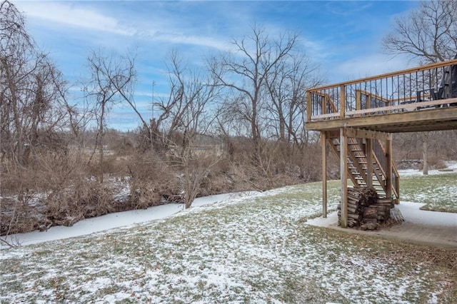 yard covered in snow with a wooden deck