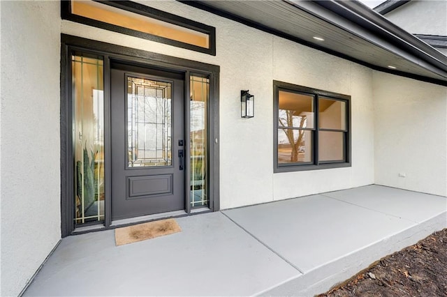 doorway to property with stucco siding