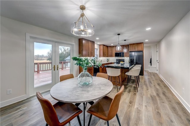 dining space with light wood-style floors, recessed lighting, baseboards, and french doors