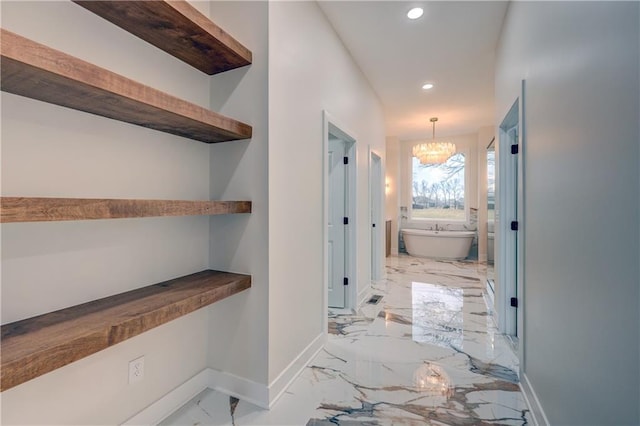 hallway featuring a chandelier, marble finish floor, recessed lighting, and baseboards