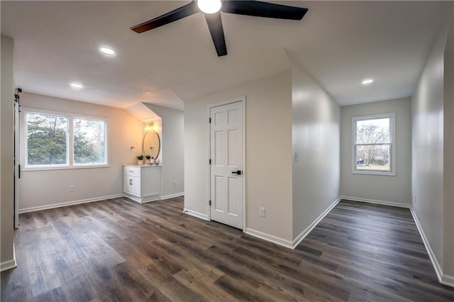 empty room with recessed lighting, dark wood finished floors, and baseboards