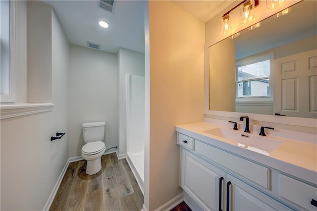 full bath featuring toilet, visible vents, a walk in shower, and wood finished floors