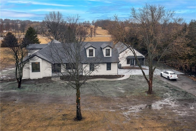 view of front of house featuring roof with shingles