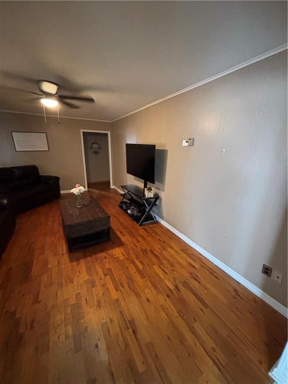 living room with hardwood / wood-style floors, crown molding, and ceiling fan