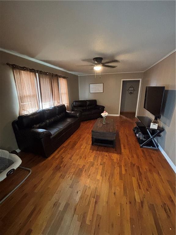 living room with hardwood / wood-style floors, crown molding, and ceiling fan