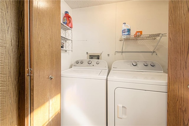 washroom featuring laundry area and separate washer and dryer