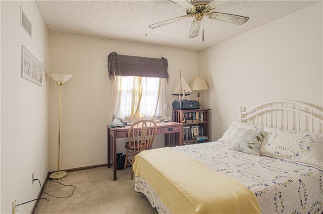 bedroom featuring light carpet, a textured ceiling, visible vents, and baseboards