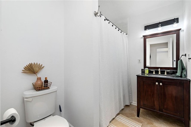 bathroom featuring toilet and vanity