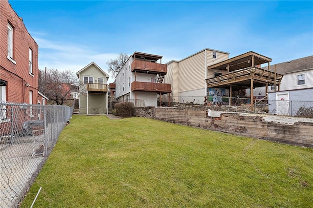 back of property featuring a yard, a fenced backyard, and a residential view