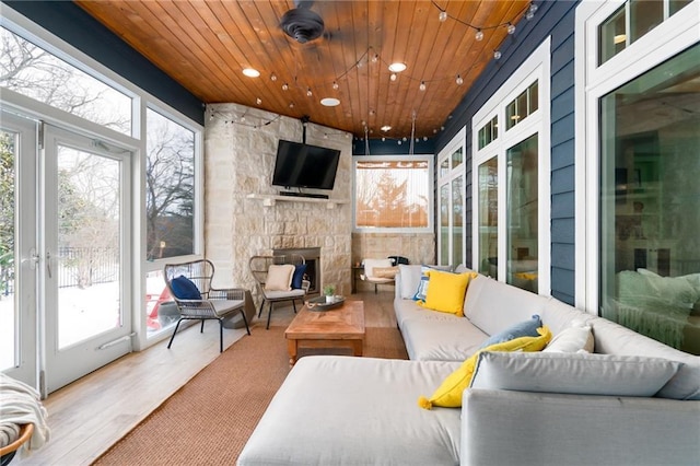 sunroom with recessed lighting, wood finished floors, and wooden ceiling