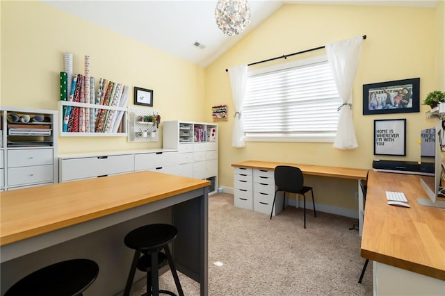 office area with baseboards, lofted ceiling, and light carpet