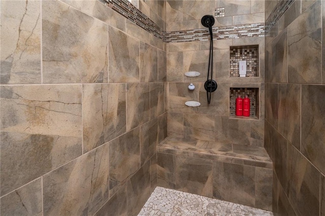 bathroom with a tile shower