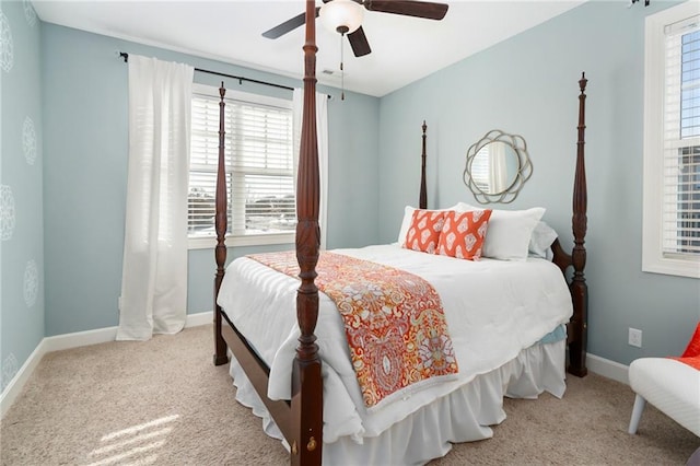 bedroom featuring baseboards, multiple windows, and carpet flooring
