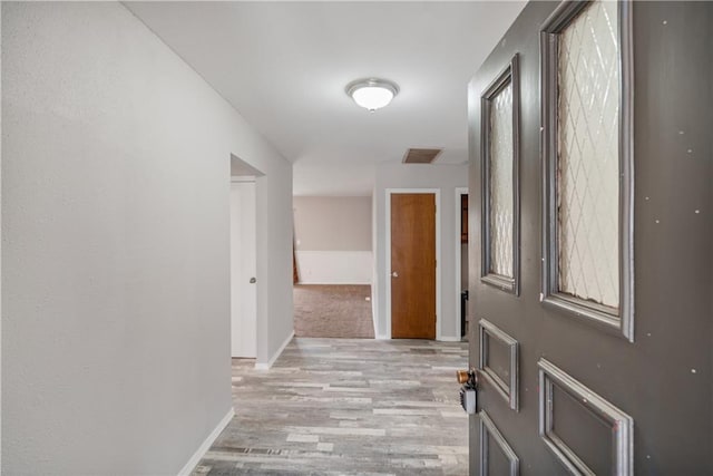 hall with light wood-type flooring