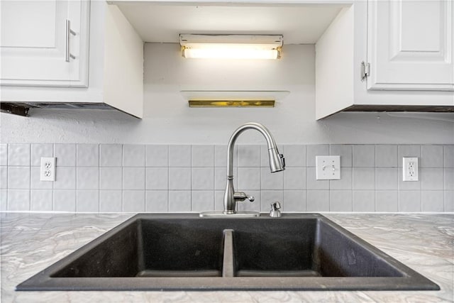 kitchen with decorative backsplash, sink, and white cabinets