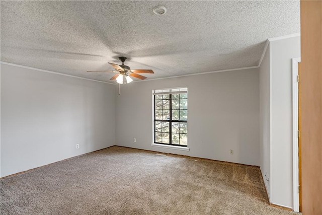 spare room featuring ceiling fan, ornamental molding, a textured ceiling, and light colored carpet