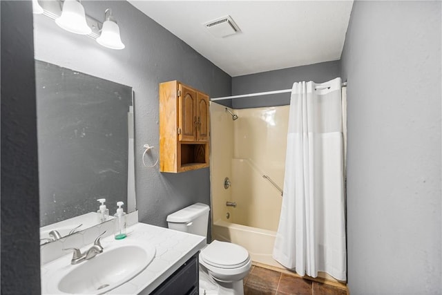 full bathroom featuring tile patterned floors, shower / bath combo with shower curtain, vanity, and toilet