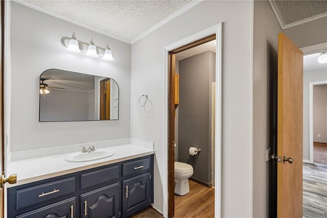 bathroom with a textured ceiling, wood-type flooring, and toilet