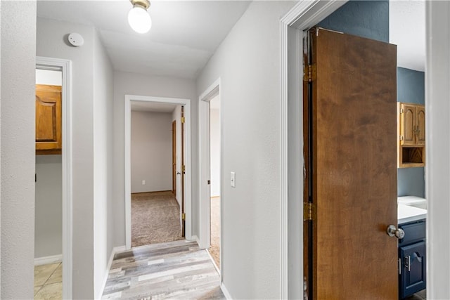 hallway with light hardwood / wood-style flooring