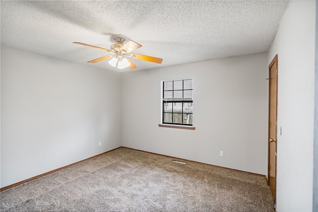 carpeted spare room featuring a textured ceiling and ceiling fan