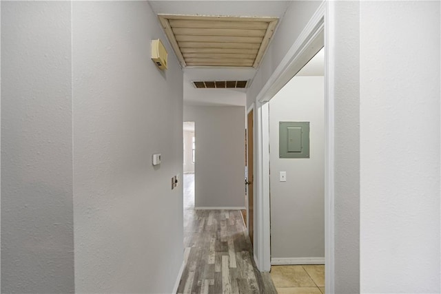 hallway featuring light wood-type flooring and electric panel