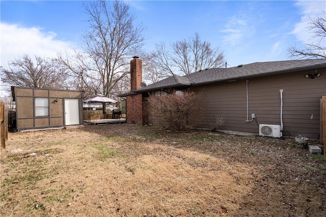 view of yard featuring ac unit, a gazebo, and an outbuilding