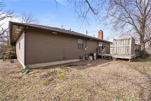 view of property exterior with a deck and central AC