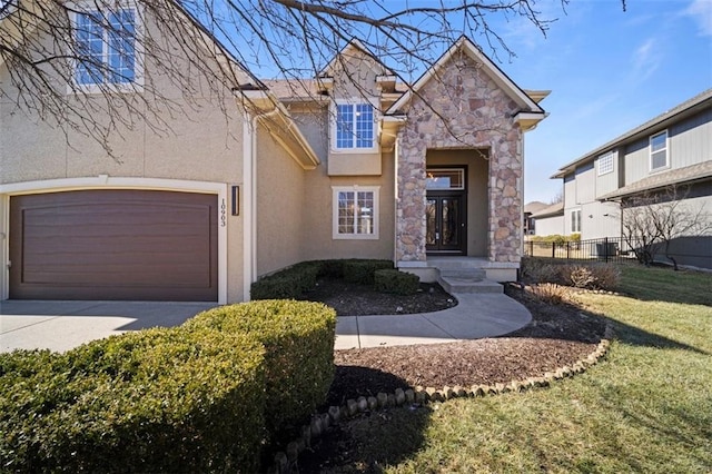 view of front of home with fence, stone siding, driveway, stucco siding, and a front lawn