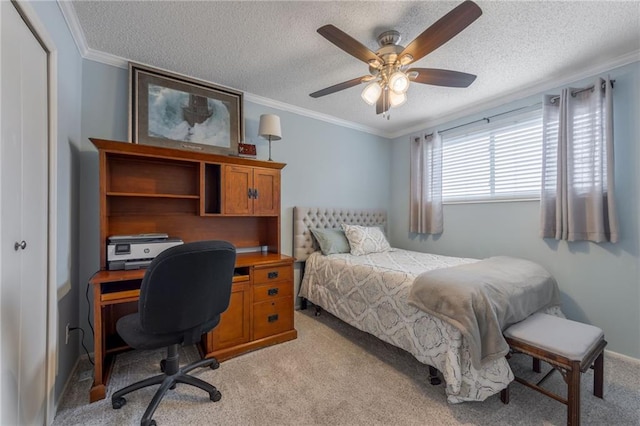 bedroom featuring crown molding, ceiling fan, a textured ceiling, and light colored carpet